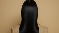 Sleek, straight black hair from behind on beige background, showcasing smooth texture and shine for beauty salon or hair care product advertising.
