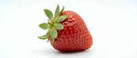 Fresh ripe strawberry with green leafy crown isolated on white background, suitable for food, nutrition, healthy eating and organic produce marketing.