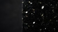 Dark granite stone surface with white and gold mineral flecks and veining, suitable for countertop, flooring, and interior design backgrounds.