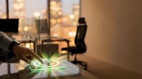 Businessman hand touching glowing green leaf hologram on desk with blurred office workspace and city lights in background, representing sustainable business and eco-friendly technology.