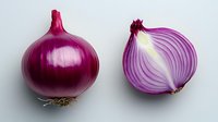 Fresh red onion whole and cut in half showing purple and white layers on light gray background, macro food photography for cooking and recipe designs.