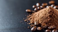 Ground coffee powder and roasted coffee beans scattered on dark background with copy space, macro food photography for cafe and restaurant menu.