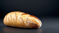 Fresh crusty bread loaf with golden brown crust on dark background, dramatic lighting highlights texture and scoring marks, food photography.
