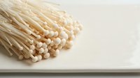 Bunch of wooden toothpicks with round heads isolated on white surface, suitable for dental hygiene, craft projects, and design mockups.