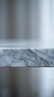 Elegant marble surface with polished metal backdrop for luxury product display and premium branding presentations.