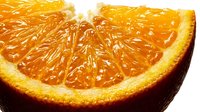 Fresh orange slice with juicy pulp and vibrant citrus segments on white background. Healthy vitamin C fruit for nutrition, cooking and beverage concepts.