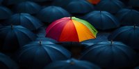 Vibrant rainbow-colored umbrella stands out among crowd of black umbrellas in rain, symbolizing individuality, uniqueness and hope against dark background.