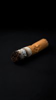 Luxury Cuban cigar with ash on dark background for premium tobacco and smoking lifestyle concepts.