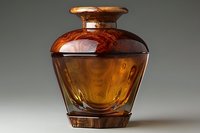 Amber glass vase with elegant curved shape and warm golden brown tones, decorative home accent piece for modern interior design and stylish decor arrangements.
