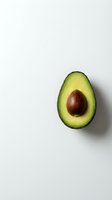 Fresh avocado half with pit on clean white background for healthy eating and nutrition concepts.
