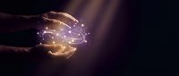 Hands releasing glowing golden light particles and energy sparks against dark background, representing innovation, magic, power, and transformation for business and technology concepts.