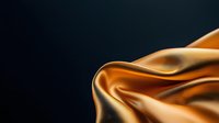 Luxurious golden silk fabric with soft waves and folds against dark background creates elegant contrast and texture for fashion and luxury design projects.