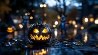 Glowing carved pumpkin with scary face on wet ground at night, illuminated by warm lights with bokeh effect creating spooky Halloween atmosphere.