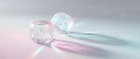 Transparent glass dice with pink dots casting rainbow light reflections on iridescent holographic surface for gaming and entertainment design.