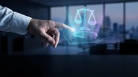 Businessman hand holding glowing scales of justice hologram above desk with city skyline background, representing legal services, law firm, compliance, and corporate governance solutions.