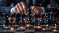 Male hands making strategic move on chess board with black pieces against dark background with glowing orange sparkles and bokeh light effects creating dramatic atmosphere.