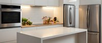 Modern white kitchen interior with island, stainless steel appliances and minimalist design for contemporary home renovation and real estate projects.
