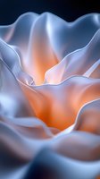 Abstract flowing fabric waves with orange and blue gradient colors creating smooth organic shapes and soft lighting effects on dark background.