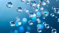 Transparent water bubbles floating on a vivid blue background with soft bokeh light effects, conveying freshness and purity.