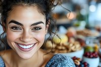 Young mixed-race woman with bright smile enjoying healthy breakfast in modern kitchen. Fresh morning lifestyle with nutritious food and positive energy.