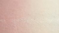 Soft pink to cream gradient textured surface with fine grain detail for backgrounds and design projects.