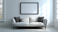 Modern white sofa with gray decorative pillows against light wall with empty black frame mockup. Bright minimalist living room interior with natural light.