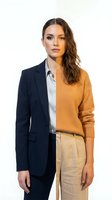 Young professional woman in split business casual and formal attire on white background. Half blazer suit, half sweater outfit for career transition concepts.