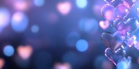 Glowing pink and blue heart shapes floating on dark background with bokeh effect creates romantic atmosphere for Valentine's Day designs and love themes.