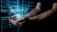 Male hands holding glowing digital hologram with security shield and network icons, representing cybersecurity, data protection, and technology innovation for business solutions.