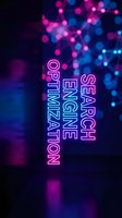 Neon search engine optimization text with vibrant pink and blue bokeh lights background for digital marketing and web technology concepts.