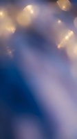 Soft bokeh background with warm golden lights scattered across blue and purple gradient, creating dreamy atmosphere for overlays and design projects.