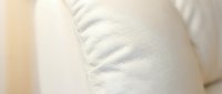 Close-up of white leather texture with natural wrinkles and folds, showcasing material quality and surface details for design and product applications.