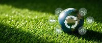 Earth globe with green recycling arrows on grass surrounded by renewable energy icons representing sustainability and environmental protection.