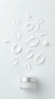 Cosmetic cream jar with white moisturizer product swatches and droplets floating above on neutral background for skincare and beauty advertising.