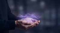 Hands holding glowing purple energy waves against blurred urban background, representing innovation, technology, power, and digital transformation for business concepts.