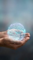 Hand holding holographic brain with mindfulness words floating above palm showing mental health balance and meditation concepts for wellness design.