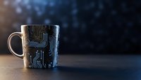 Modern coffee mug with electronic circuit board pattern on dark background. Technology themed drinkware for office and tech enthusiasts.
