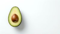Fresh avocado half with pit on white background isolated for healthy eating and cooking designs.