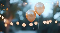 Peach balloons floating against blurred bokeh lights at dusk, creating festive atmosphere for celebration or party backdrop.