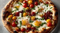 Artisan pizza topped with fresh eggs, colorful cherry tomatoes, creamy cheese and herbs on rustic wooden surface for gourmet cooking concepts.