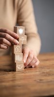Businessman stacking wooden blocks with insurance icons including shield, umbrella, house, coins and handshake representing financial protection services.
