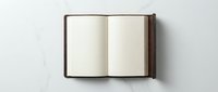 Open blank notebook with brown leather cover on white background, ready for writing, journaling, planning and creative projects.