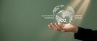 Business professional holding glowing CO2 bubble with sustainable business and climate action concepts for environmental responsibility presentations.