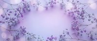 Delicate purple baby's breath flowers arranged in elegant frame on soft lavender background for wedding invitations, greeting cards and romantic designs.