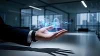 Businessman hand presenting holographic security shield icon in modern office environment for cybersecurity and data protection concepts.
