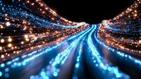 Abstract light trails creating dynamic motion effect with blue and orange glowing streaks against dark background, suggesting speed, technology and digital transformation.