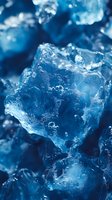 Macro photography of crystalline ice formation with water droplets and bubbles trapped inside, creating abstract patterns in deep blue tones and textures.