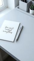 Minimalist desk with notebook reading you cant control everything, pen, and succulent plant in soft natural light, mindfulness concept.