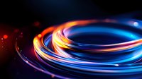 Glowing spiral light trails in orange and blue colors against dark background create dynamic motion effect with vibrant neon illumination and energy flow pattern.