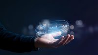 Businessman holding glowing holographic dashboard with charts and analytics data, representing digital transformation and business intelligence technology.